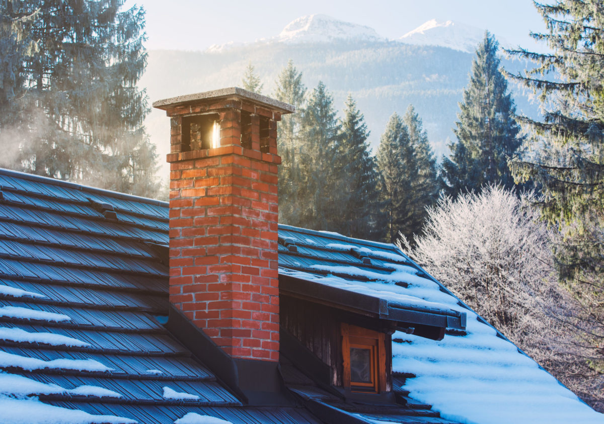 close up of chimney with flashing onto of a roof
